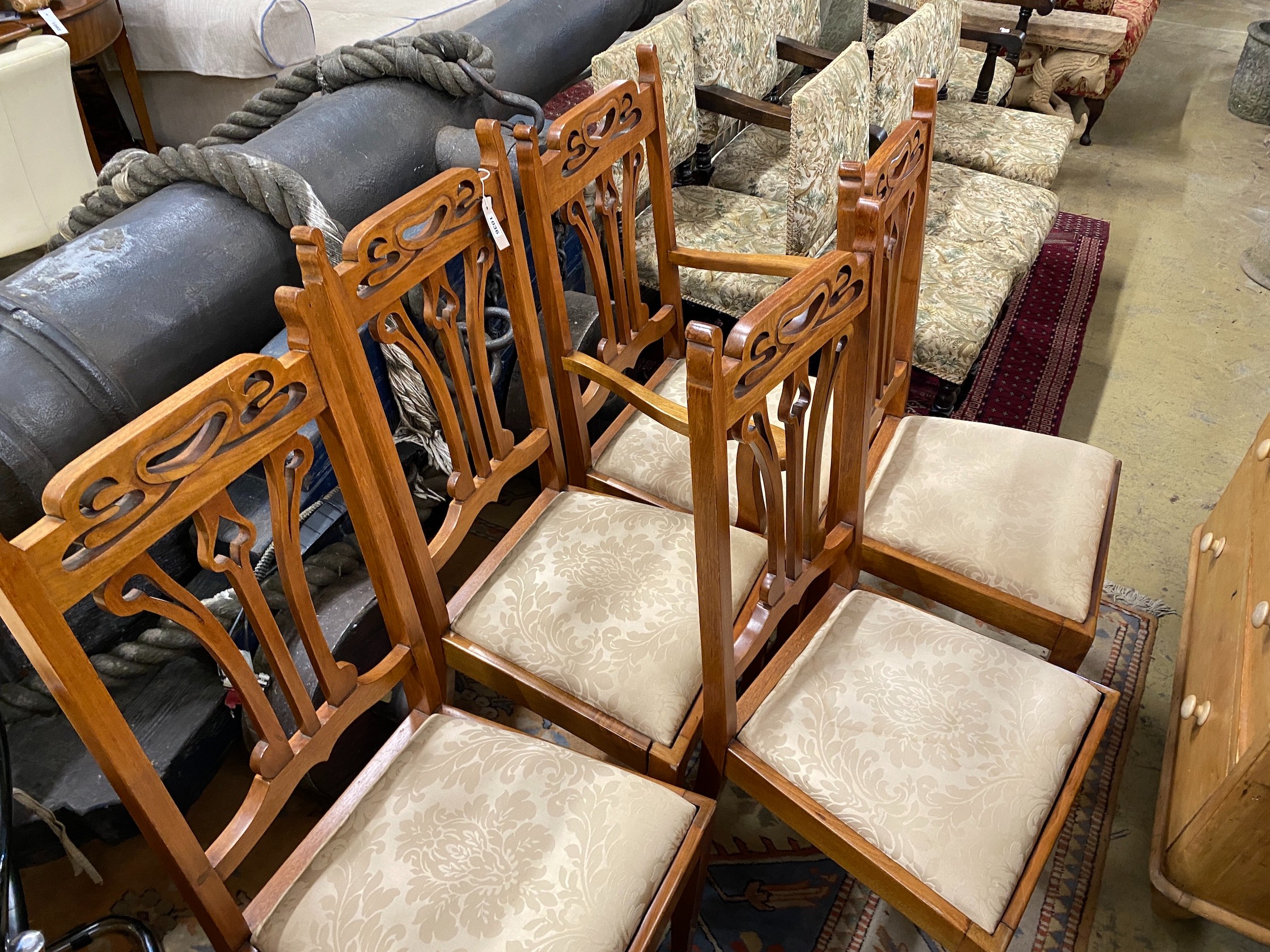 Five Art Nouveau walnut dining chairs, one with arms